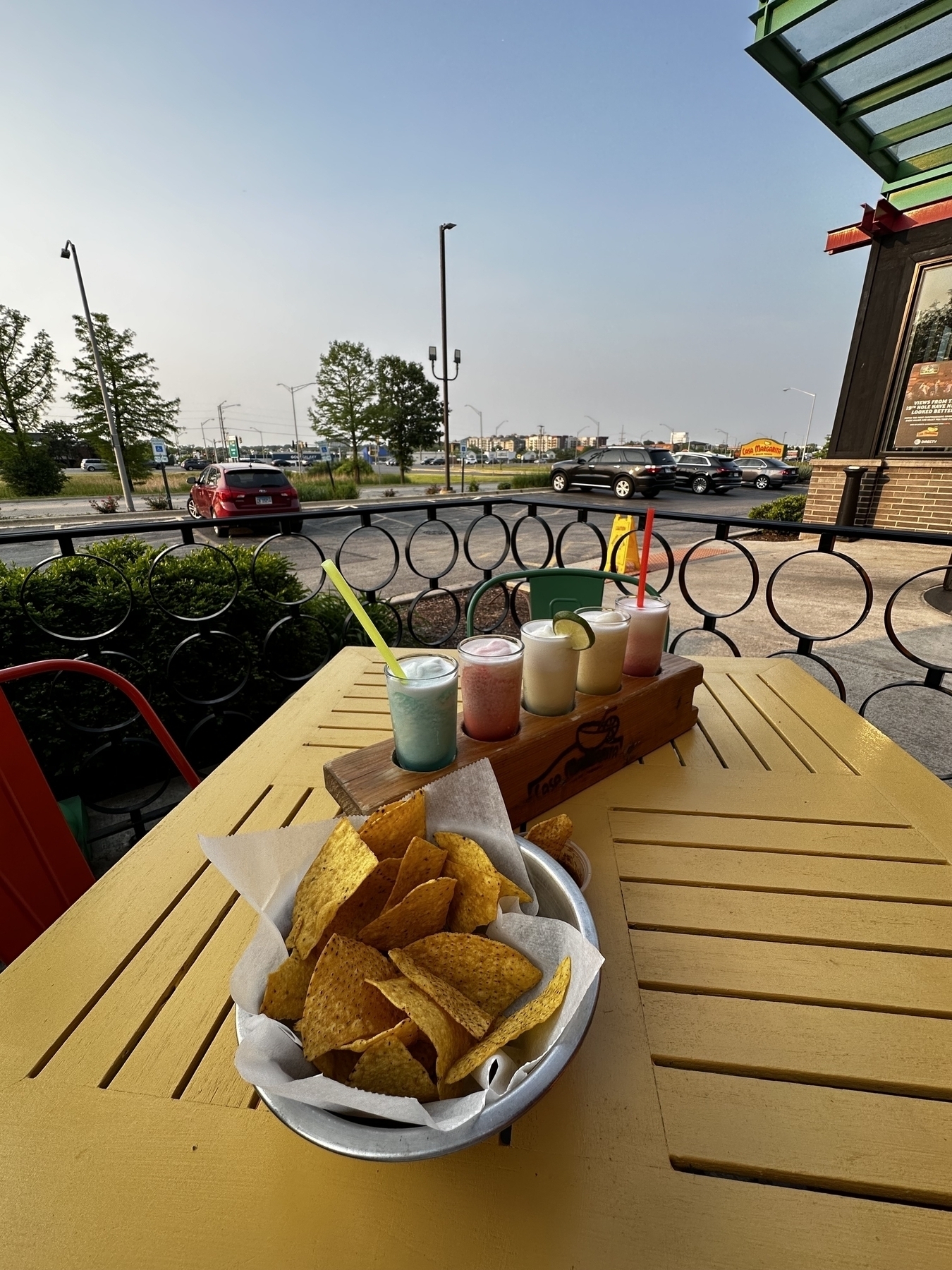 A flight of frozen margaritas and a bowl of tortilla chips