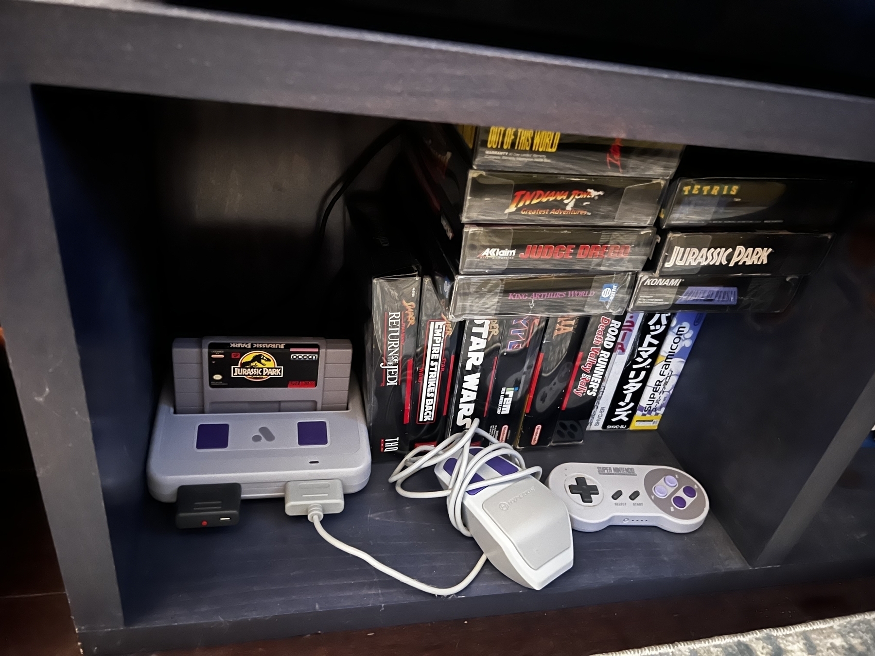 Jurassic Park for SNES in an Analogue Super NT next to a wireless SNES Switch Online controller and a Hyperkin SNES Mouse